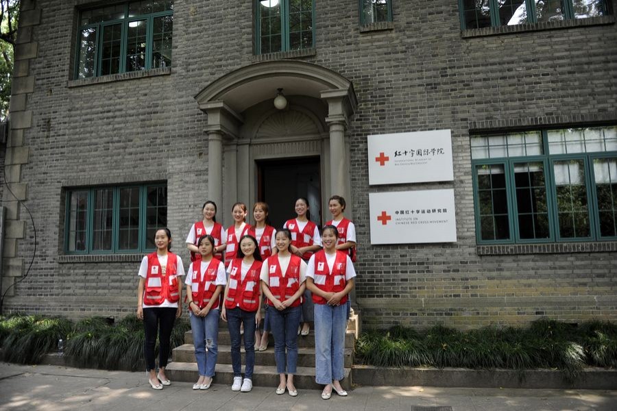 Student volunteers pose for photos in front of the office of the newly-established International Academy of Red Cross and Red Crescent in Suzhou University in Suzhou, east China's Jiangsu Province, Aug. 31, 2019. (Xinhua)