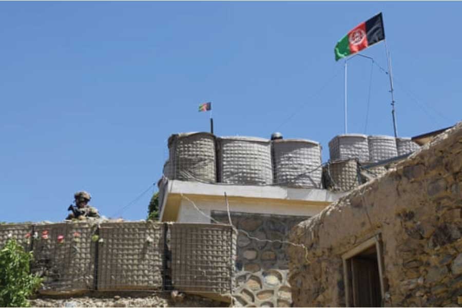 A US adviser stands at the fortification of a base during deployment to Afghanistan in June 2019. The collapse of protracted US-Taliban negotiations has triggered fears of a spike in violence. 	—Photo: Handout/Reuters