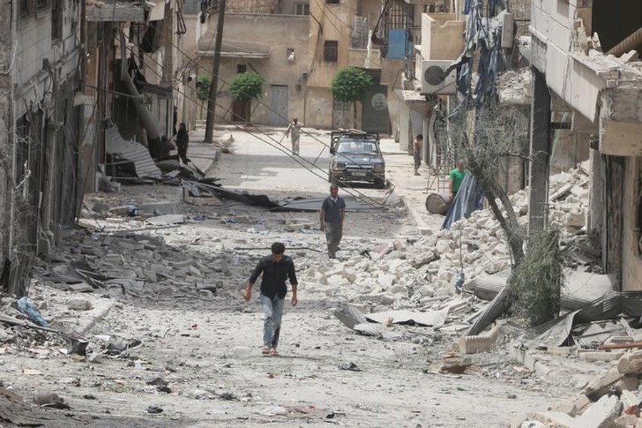 People walk on the rubble of damaged buildings after an airstrike in the rebel held area of Aleppo's Baedeen district, Syria, May 3, 2016. Reuters/Files