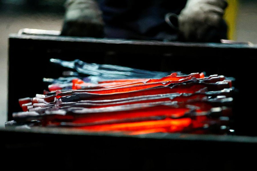 FILE PHOTO - Unfinished pliers still glow after being hot-formed by a hammer at the factory of Knipex, in Wuppertal, western Germany, October 25, 2016. REUTERS/Wolfgang Rattay