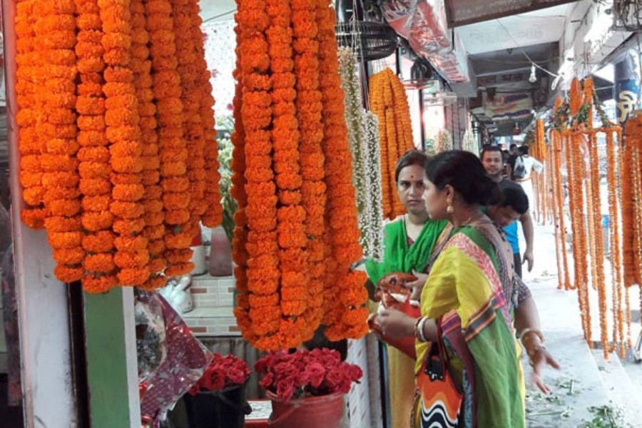 Buyers purchasing flowers at a shop on the Victoria Road Flower Market in Tangail town  	— FE Photo