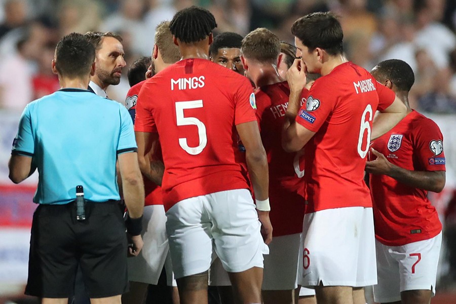 England players speak with manager Gareth Southgate as the match is temporarily stopped during the first half — Reuters photo