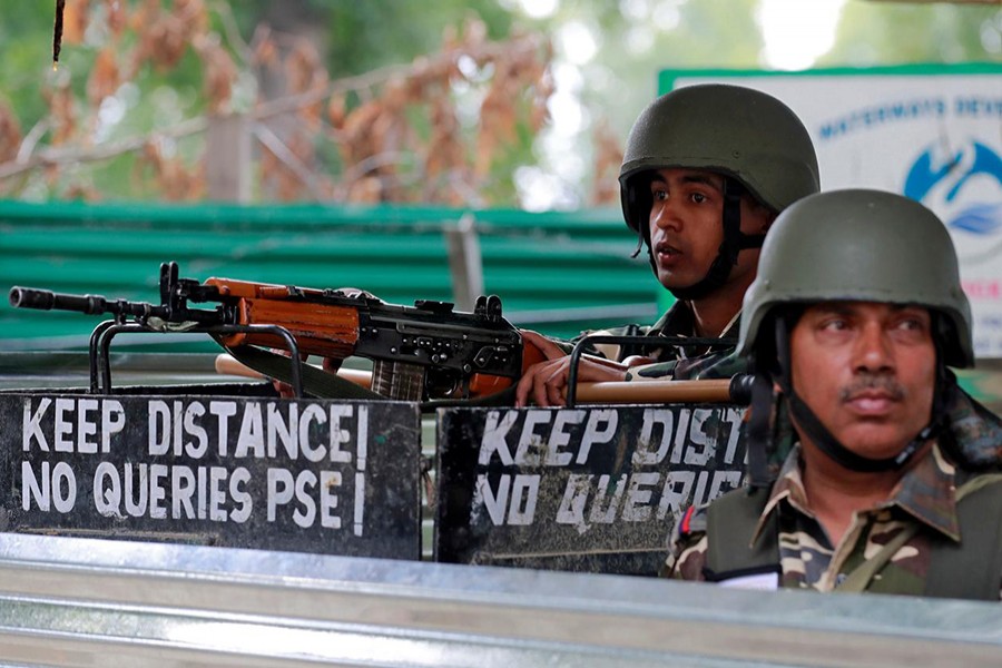 Indian security force personnel keep guard alongside a road during restrictions after the government scrapped the special constitutional status for Kashmir, in Srinagar on August 15, 2019 — Reuters/Files