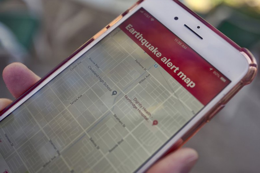 A mobile phone customer looks at an earthquake warning application on their phone in Los Angeles — AP file photo used for representational purpose