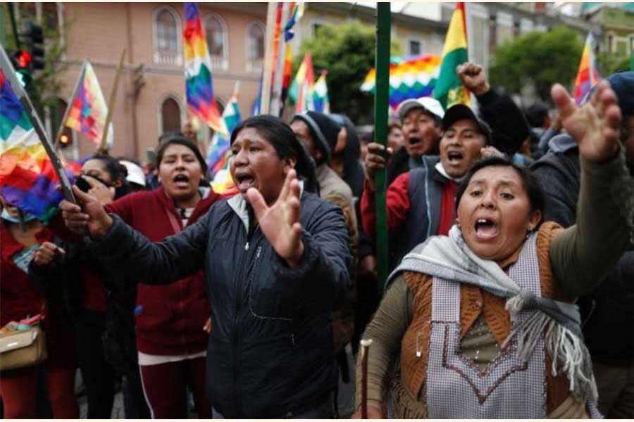 Supporters of former president Evo Morales carry "wiphala" flags that represent indigenous peoples. 	—Photo: AP