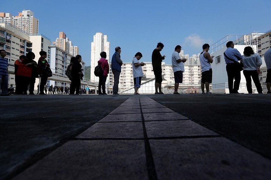 Voters queue at a polling station during district council local elections in Hong Kong, China on Sunday — Reuters photo