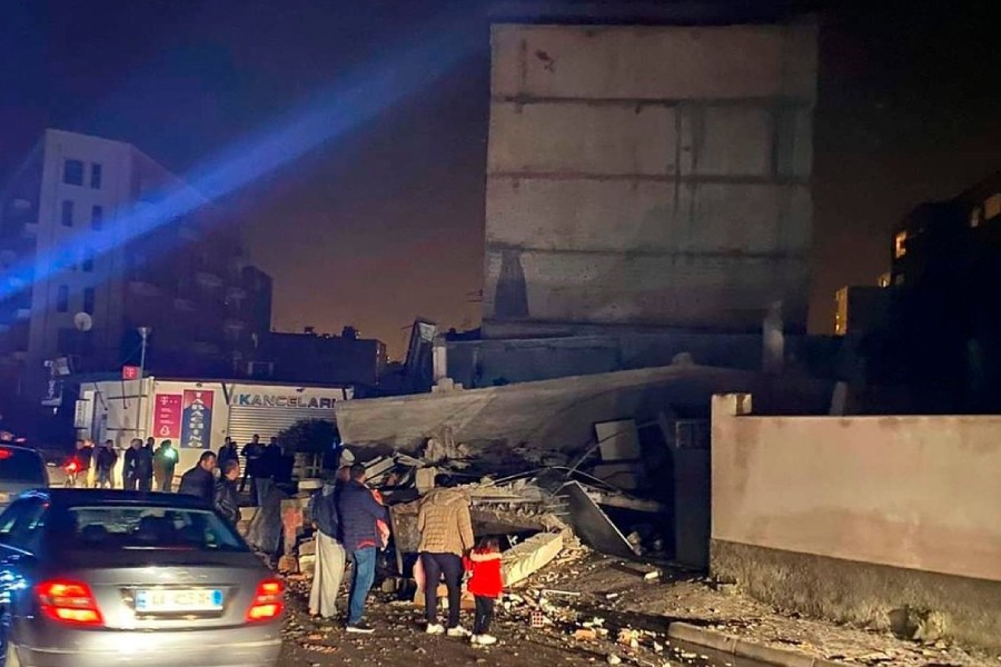 People look at a damaged building after an earthquake in Durres, western Albania, Tuesday, Nov. 26, 2019 - AP Photo