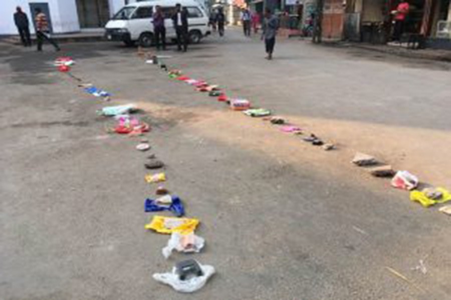 Due to a sudden suspension of selling onion through TCB outlets in Rajshahi on Saturday, customers put bags and trashes in lines marking their serials so that they can queue up at the same spot tomorrow       	— FE photo