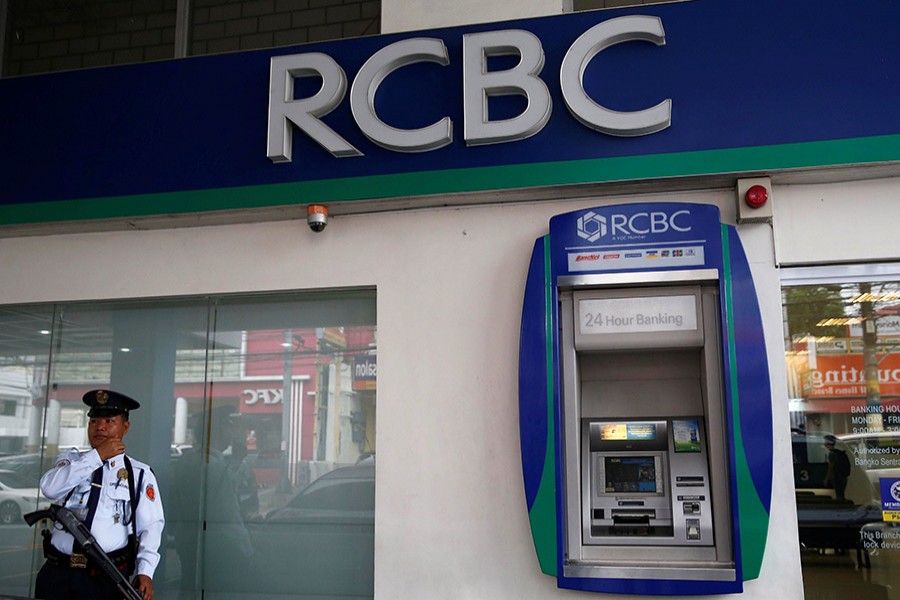 A security guard stands guard outside a branch of Rizal Commercial Banking Corporation (RCBC) in Paranaque city, Metro Manila in Philippines on August 2, 2016 — Reuters/Files