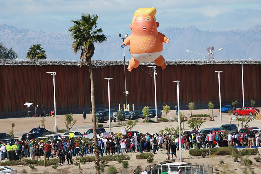 A 'Baby Trump' balloon flies over the US-Mexico border fence — Reuters/Files