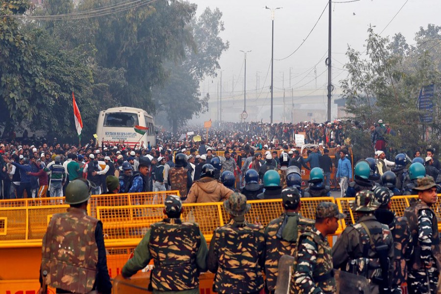 Demonstrators shout slogans behind a police barricade during a protest against a new citizenship law in Jafrabad, an area of Delhi, India, December 20, 2019. Reuters