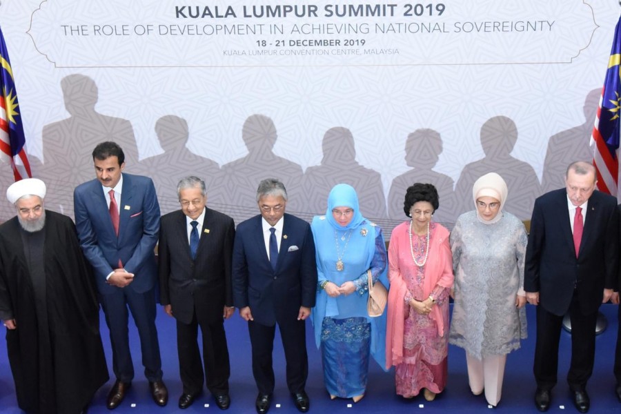 Iranian president Hassan Rouhani, Qatar's emir Sheikh Tamim bin Hamad Al Thani, Malaysia's prime minister Mahathir Mohamad, Malaysia's King Sultan Abdullah Sultan Ahmad Shah, Malaysia's queen Tunku Azizah Aminah Maimunah Iskandariah, Malaysia's first lady Siti Hasmah Mohamad Ali, Turkey's first lady Emine Erdogan and Turkey's president Recep Tayyip Erdogan pose for a photograph during Kuala Lumpur Summit in Kuala Lumpur, Malaysia, December 19, 2019. Malaysia Department of Information/Handout via Reuters