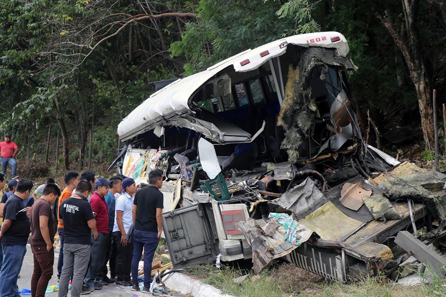 People are pictured on the scene of a collision between a passenger bus and a trailer truck early on Saturday in Gualan, near Guatemala's Atlantic coast, Guatemala on December 21, 2019 — Reuters photo