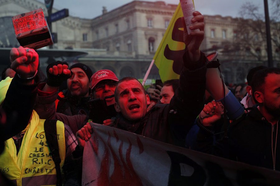 French union members and workers demonstrating in Paris on Thursday after 22 days on a strike against pension reform plans. -AP Photo