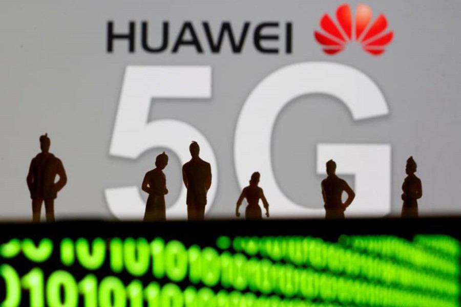 Small toy figures are seen in front of a displayed Huawei and 5G network logo in this illustration picture, March 30, 2019. Reuters/Illustration