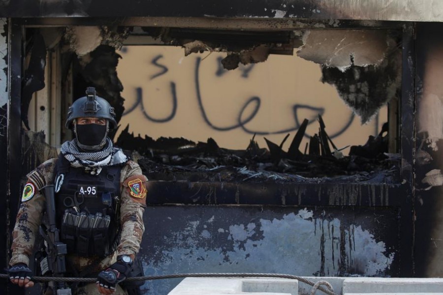 A member of Iraqi security forces stands guard during a protest to condemn air strikes on bases belonging to Hashd al-Shaabi (paramilitary forces), in Baghdad, Iraq, January 01, 2020. Reuters