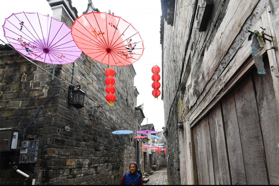 People walk in Liukeng Village of Le'an County, east China's Jiangxi Province, October, 29, 2019. Located in the southwestern Le'an County, Liukeng village was listed as a key cultural heritage site under state-level protection in 2001. About 260 ancient buildings have been well-preserved in the village. Xinhua/Files