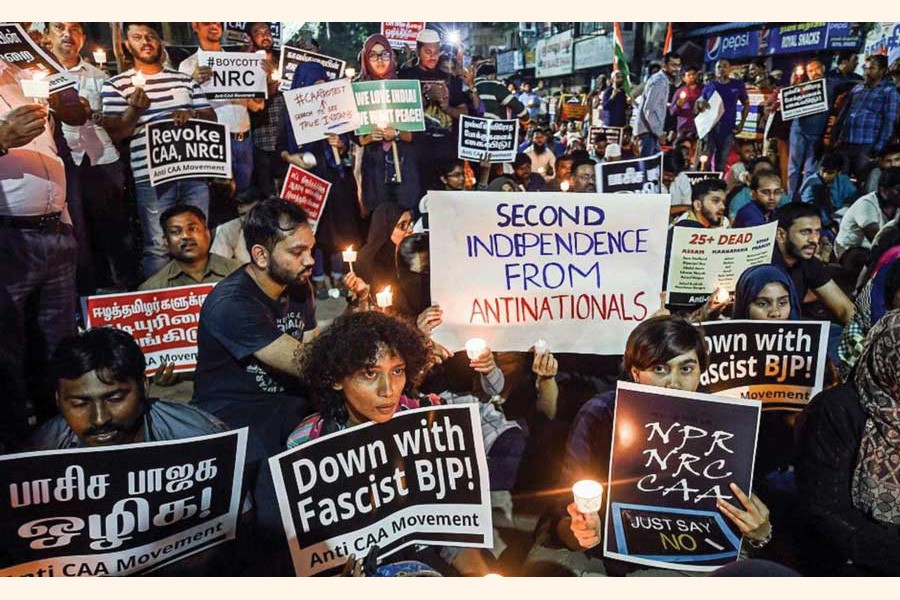 Protesters raise slogans at a midnight candle-light demonstration against the CAA during the New Year celebrations in Chennai, India.   —Photo:  Courtesy PTI via the Internet