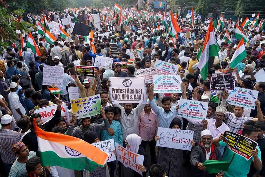 Demonstrators holding placards and flags during a protest rally against a new citizenship law, in Hyderabad, India, on Saturday. -Reuters Photo