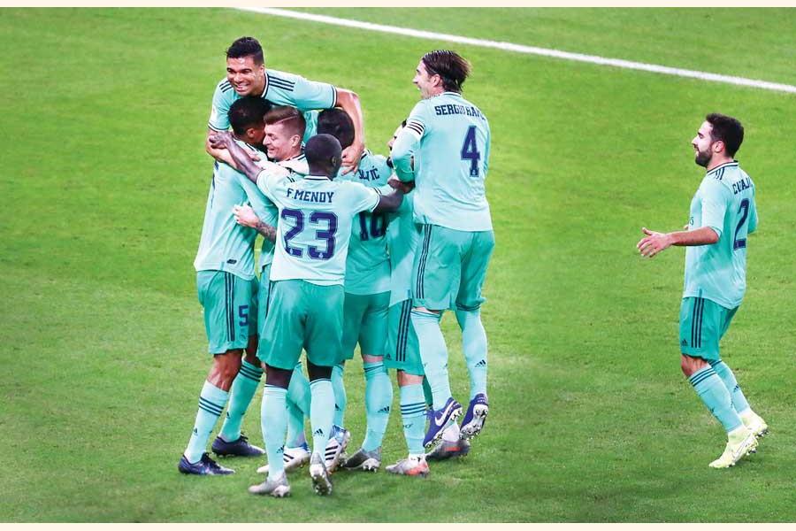 Real Madrid's Toni Kroos celebrating with teammates after scoring their first goal during the Spanish Super Cup match against Valencia on Wednesday 	— Reuters