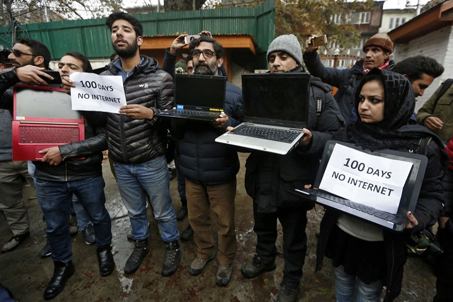 Kashmiri journalists display laptops and placards during a protest demanding restoration of internet service, in Srinagar on November 12, 2019 — REUTERS/Files