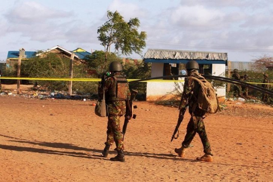 Kenya Defence Forces soldiers walk near the scene of an overnight attack on a residential complex in Mandera town at the Kenya-Somalia border July 7, 2015. REUTERS/Stringer