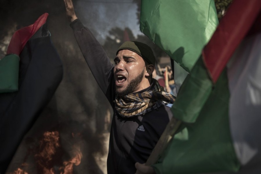 Palestinian protesters chant angry slogans during a protest against the US Mideast peace plan, in Gaza City, Monday, Jan 28, 2020. (AP Photo/Khalil Hamra)