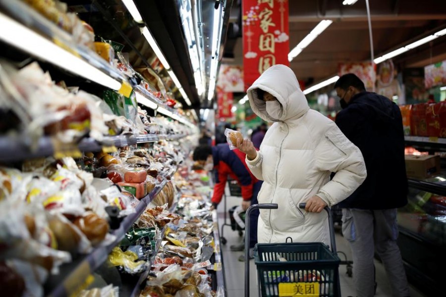 People wearing face masks look for products at a supermarket, as the country is hit by an outbreak of the new coronavirus, in Beijing, China, January 31, 2020. Reuters