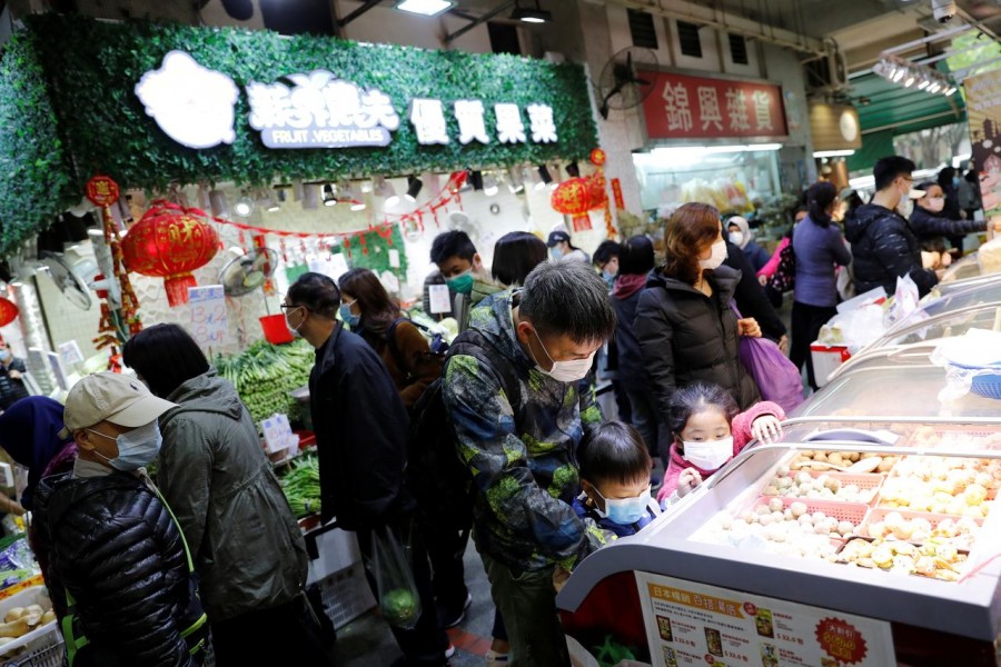 Customers wear masks as they are buying foods at a food market in Hong Kong, China . REUTERS/Tyrone Siu/File Photo