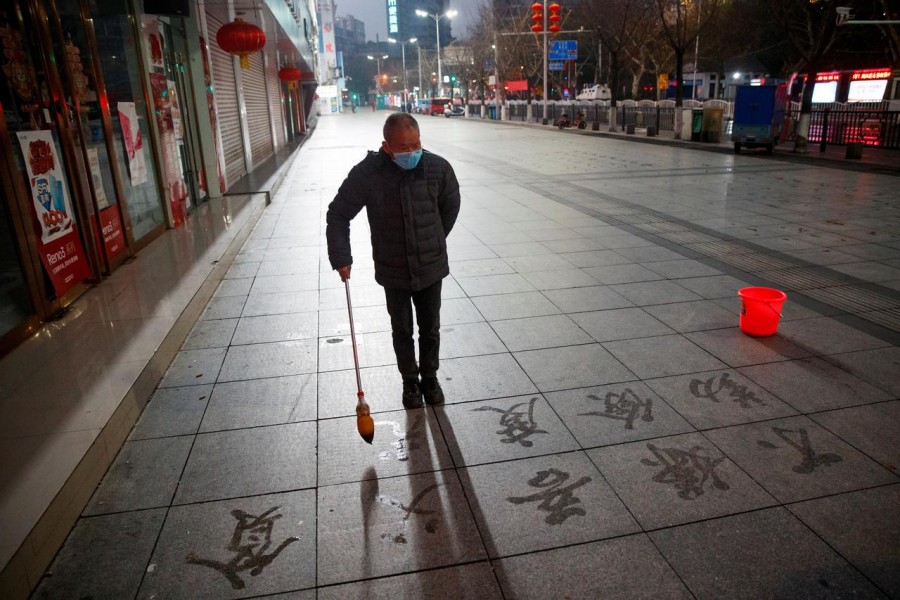 A man wears a face mask as he practices calligraphy of Chinese characters on a pavement as the country is hit by an outbreak of the novel coronavirus in Jiujiang, Jiangxi province, China, February 3, 2020. Reuters