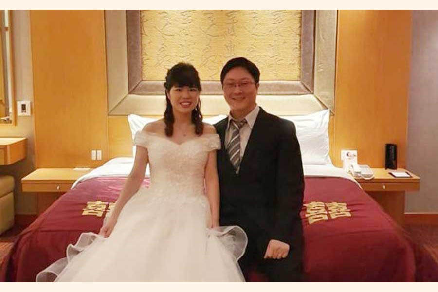 The couple enjoying the celebration from their wedding room  	— BBC