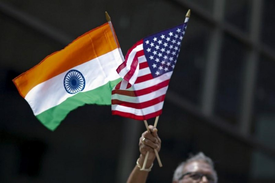 A man holds the flags of India and the US while people take part in the 35th India Day Parade in New York, August 16, 2015. Reuters/File Photo