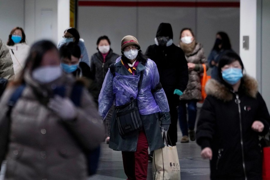 People wearing face masks walk inside a subway station, as the country is hit by an outbreak of the novel coronavirus, in Shanghai, China, February 17, 2020. Reuters