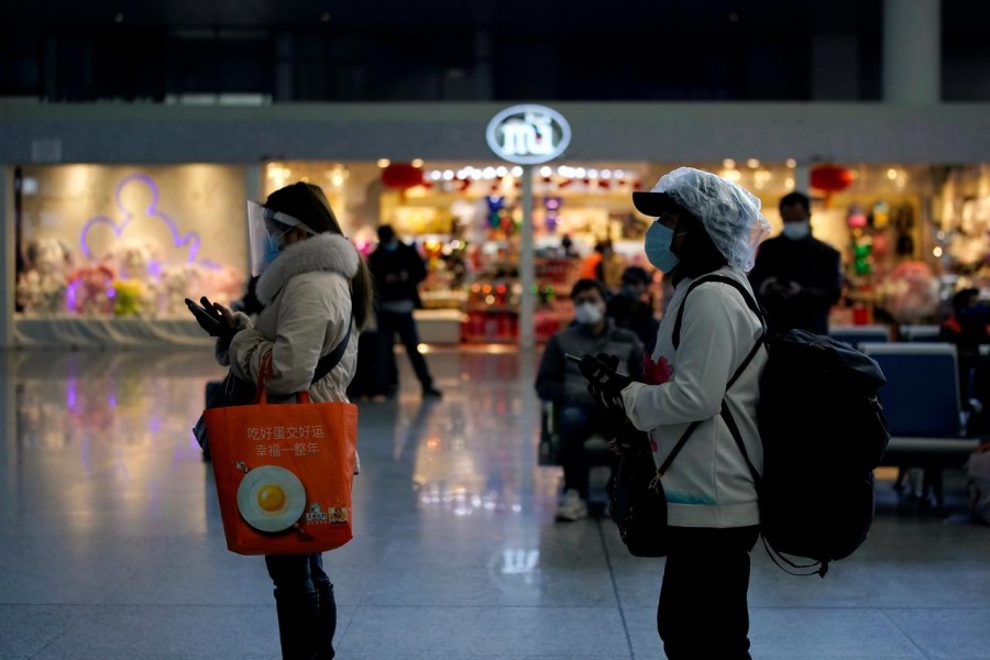 Travellers with face masks and shields are seen at the Shanghai Hongqiao Railway Station on the last day of the Spring Festival travel rush, as the country is hit by an outbreak of the novel coronavirus, in Shanghai, China, February 18, 2020. Reuters