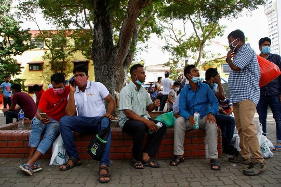 Migrant workers mostly from Bangladesh wear masks as they enjoy a day off on a weekend in Singapore, February 23, 2020 —Reuters