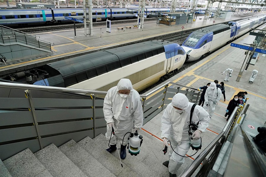 Employees from a disinfection service company sanitise the floor of Seoul Railway Station in Seoul, South Korea on February 25, 2020 — Reuters photo