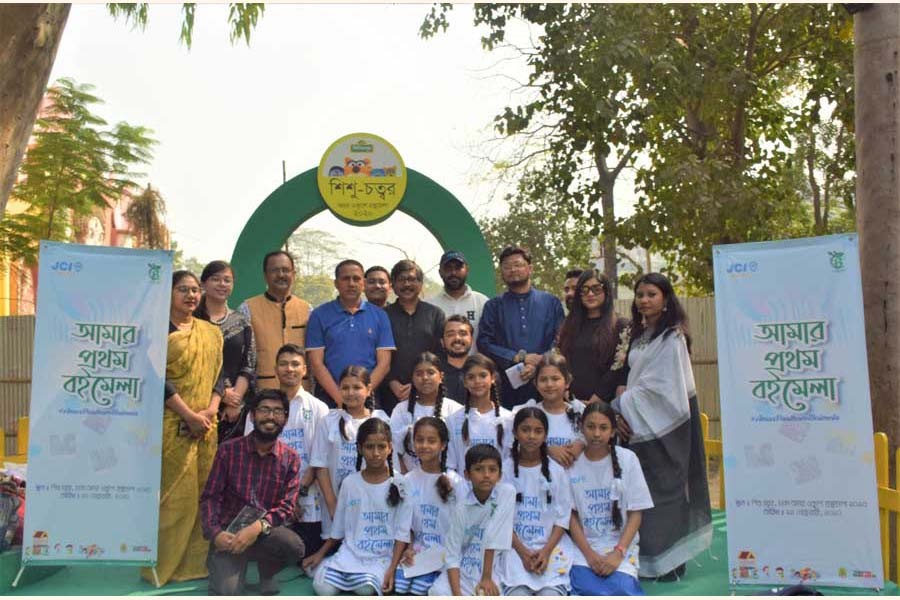 Children taken to Dhaka Ekushe Book Fair for the event 'Amar Prothom Boimela' pose with the organisers