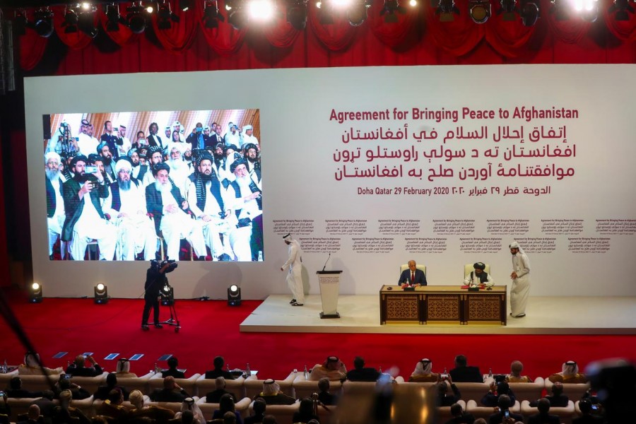 Mullah Abdul Ghani Baradar, the leader of the Taliban delegation, signs an agreement with Zalmay Khalilzad, U.S. envoy for peace in Afghanistan, at a signing agreement ceremony between members of Afghanistan's Taliban and the U.S. in Doha, Qatar February 29, 2020. REUTERS/Ibraheem al Omari