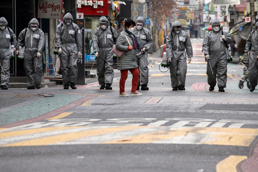 South Korean soldiers in protective gear sanitize a shopping street in Seoul, South Korea on March 4, 2020 — Reuters photo