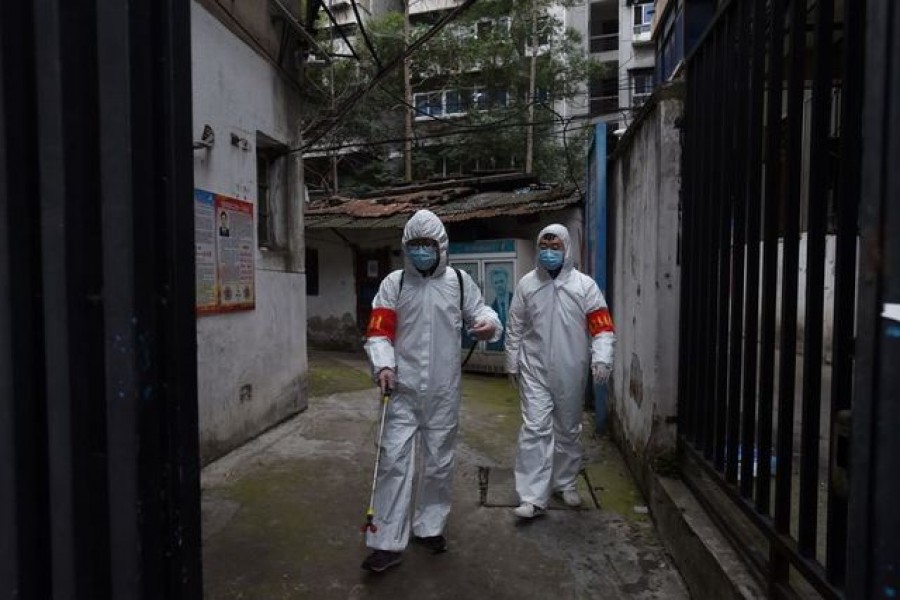 Community workers in protective suits disinfect a residential compound in Wuhan, the epicentre of the novel coronavirus outbreak, Hubei province, China March 6, 2020 — Reuters