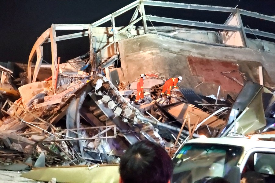 Rescue workers are seen on the site where a hotel being used for the novel coronavirus quarantine collapsed in the southeast Chinese port city of Quanzhou, Fujian province, China March 7, 2020. cnsphoto via REUTERS.