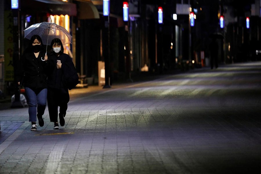 Women wearing masks make their way in downtown amid the rise in confirmed cases of the coronavirus disease (COVID-19) in Daegu, South Korea, March 9, 2020 — Reuters