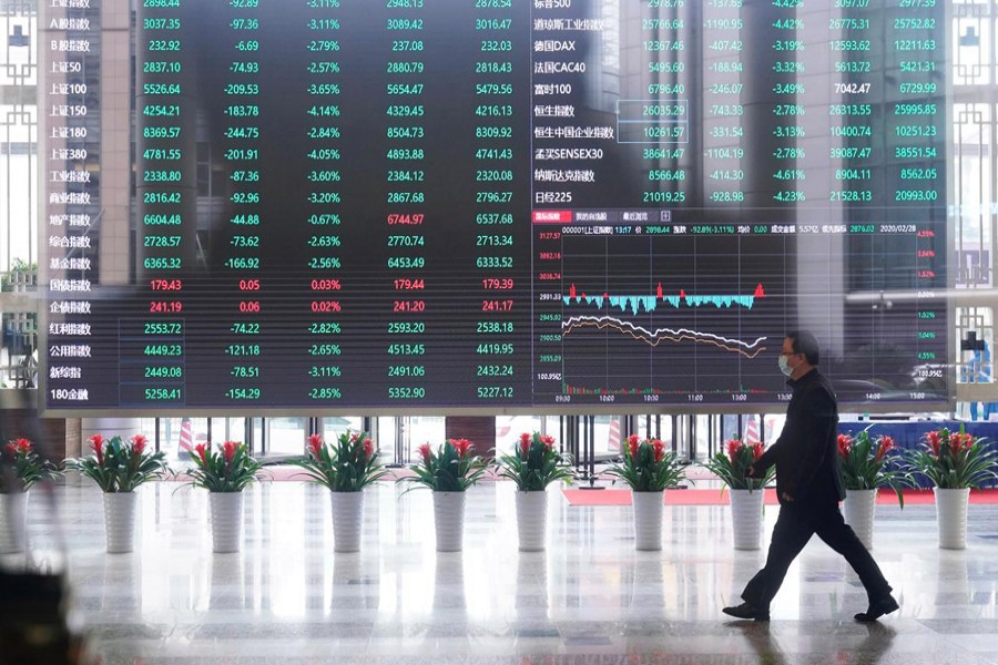 A man wearing a face mask is seen inside the Shanghai Stock Exchange building, as the country is hit by a novel coronavirus outbreak, at the Pudong financial district in Shanghai, China, February 28, 2020 — Reuters/Files