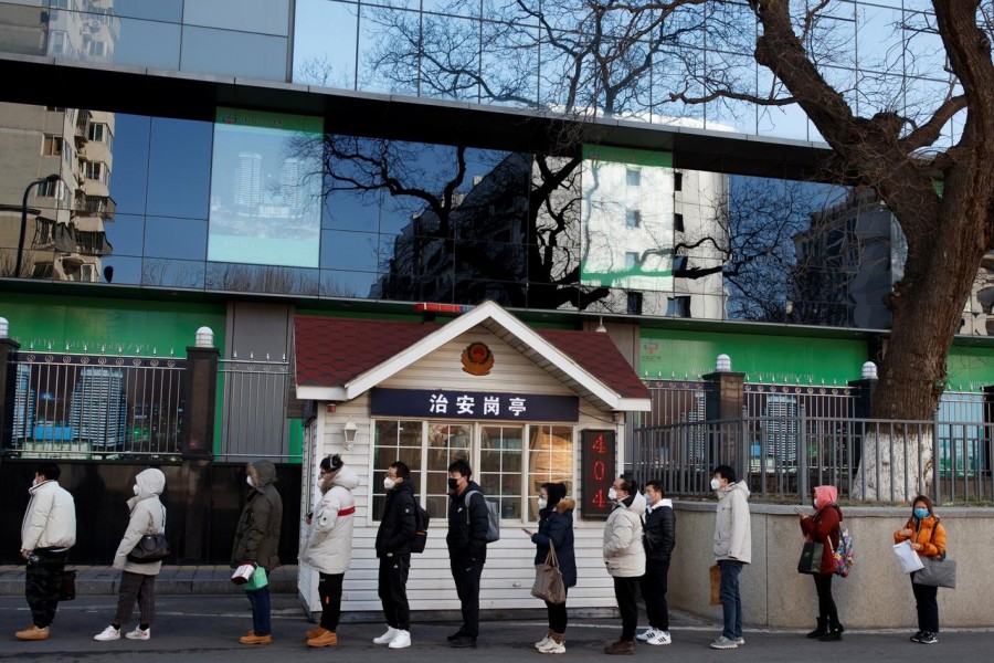 People line up to register their temperature and personal details as they arrive for work at an office building in Beijing, as the country is hit by an outbreak of the novel coronavirus, China on March 3, 2020 — Reuters photo