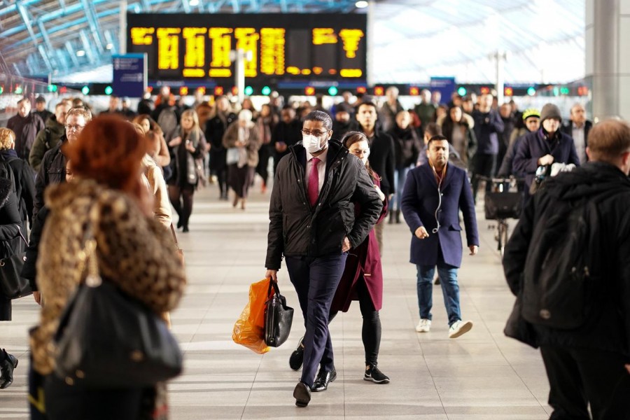 FILE PHOTO: A man is seen wearing a protective face mask at Waterloo station in London, Britain, March 6, 2020. REUTERS/Henry Nicholls