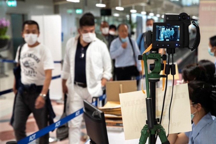 A thermographic device displays the temperature of arriving passengers before they enter immigrations at Bangkok's Suvarnabhumi International Airport, Thailand, March 14, 2020. — Reuters