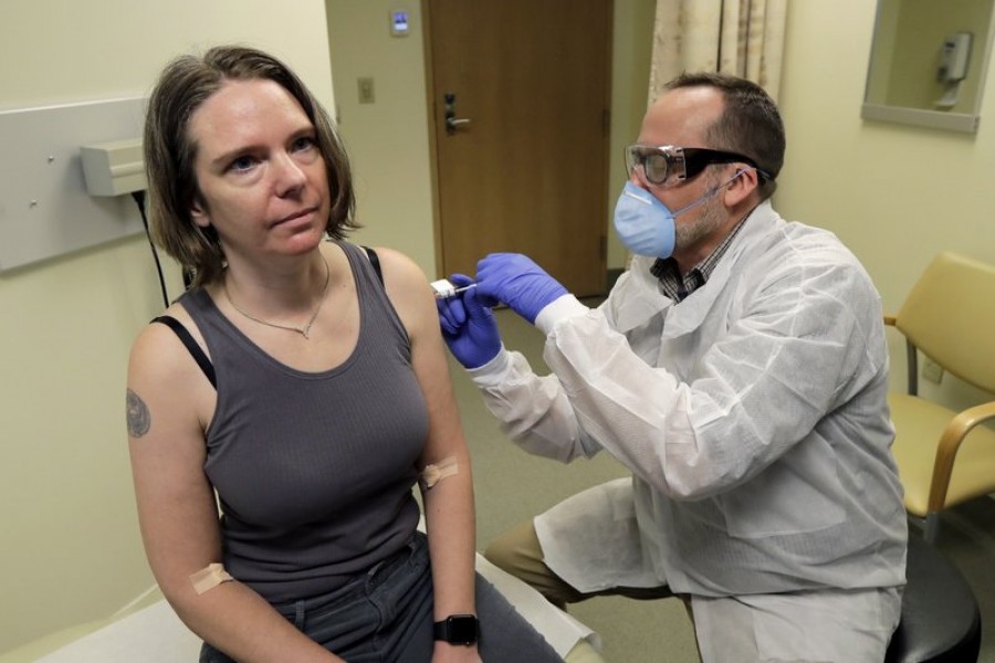 A pharmacist gives Jennifer Haller, left, the first shot in the first-stage safety study clinical trial of a potential vaccine for COVID-19, the disease caused by the new coronavirus, Monday, March 16, 2020, at the Kaiser Permanente Washington Health Research Institute in Seattle. —AP