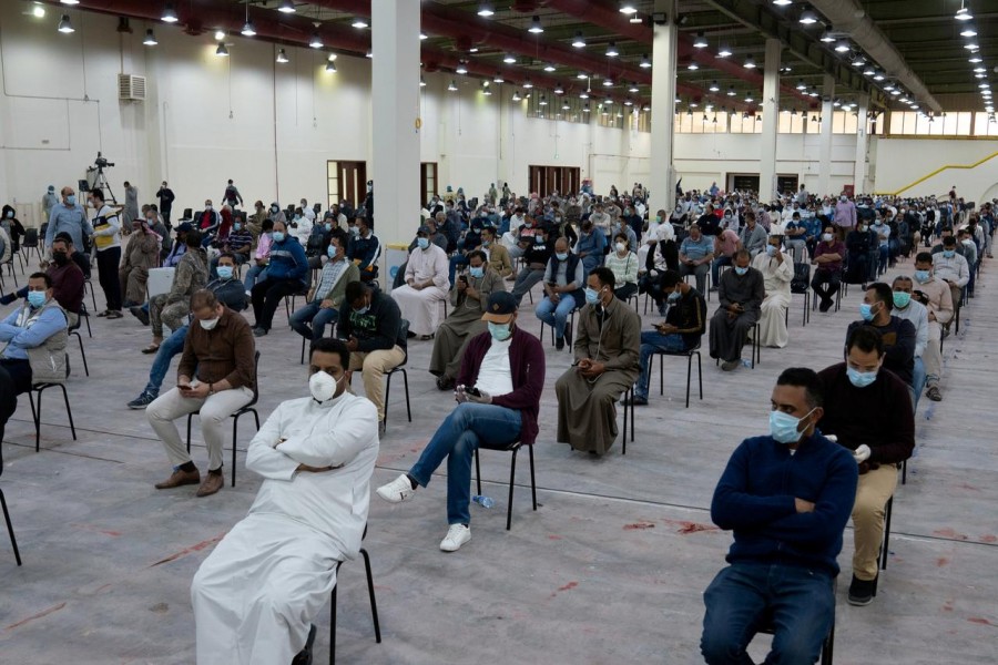 FILE PHOTO: Expatriates wait for mandatory coronavirus testing in a makeshift testing centre in Mishref, Kuwait March 14, 2020. REUTERS/Stephanie McGehee