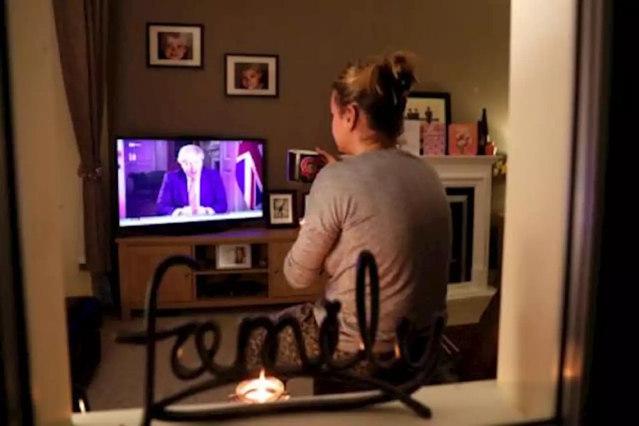 A woman watches British Prime Minister Boris Johnson's press conference as the spread of coronavirus disease (COVID-19) continues in Ouston, Britain on March 23, 2020 — Reuters photo