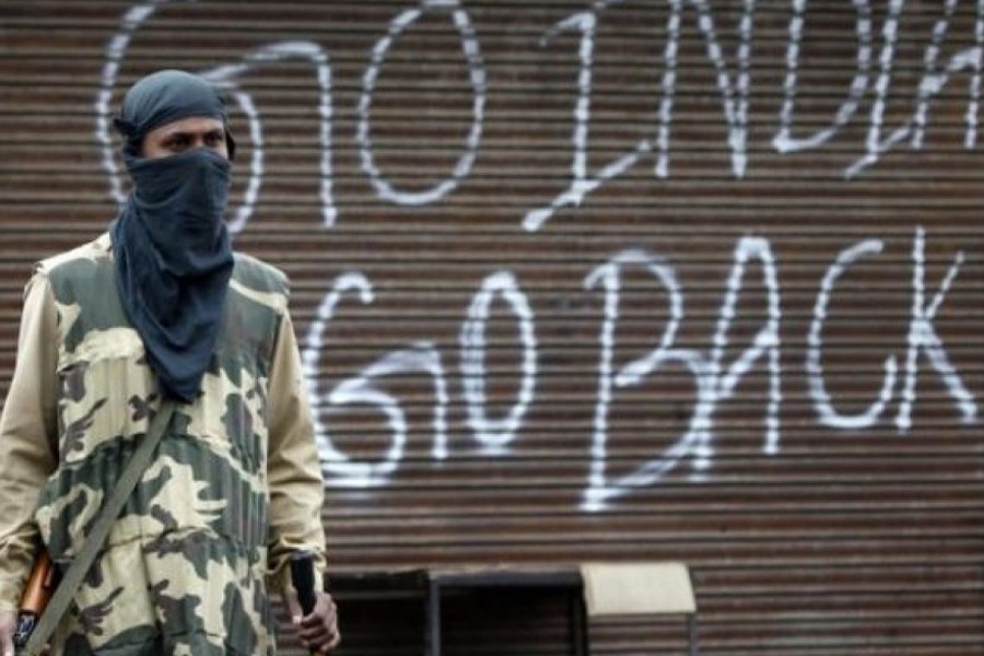 An Indian police officer stands guard near a closed shop during a curfew in Srinagar — Reuters/Files